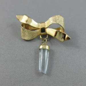 Ribbon brooch with a light blue stone